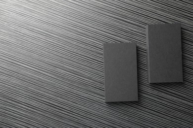 Blank black business cards on wooden table, top view. Mockup for design