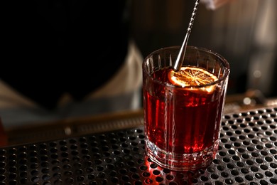 Fresh alcoholic cocktail on counter in bar, closeup. Space for text