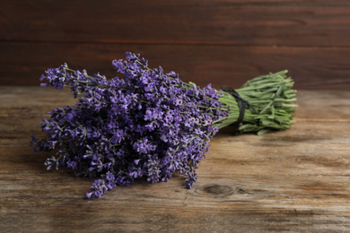 Beautiful fresh lavender bouquet on wooden table