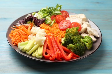 Balanced diet and healthy foods. Plate with different delicious products on blue wooden table