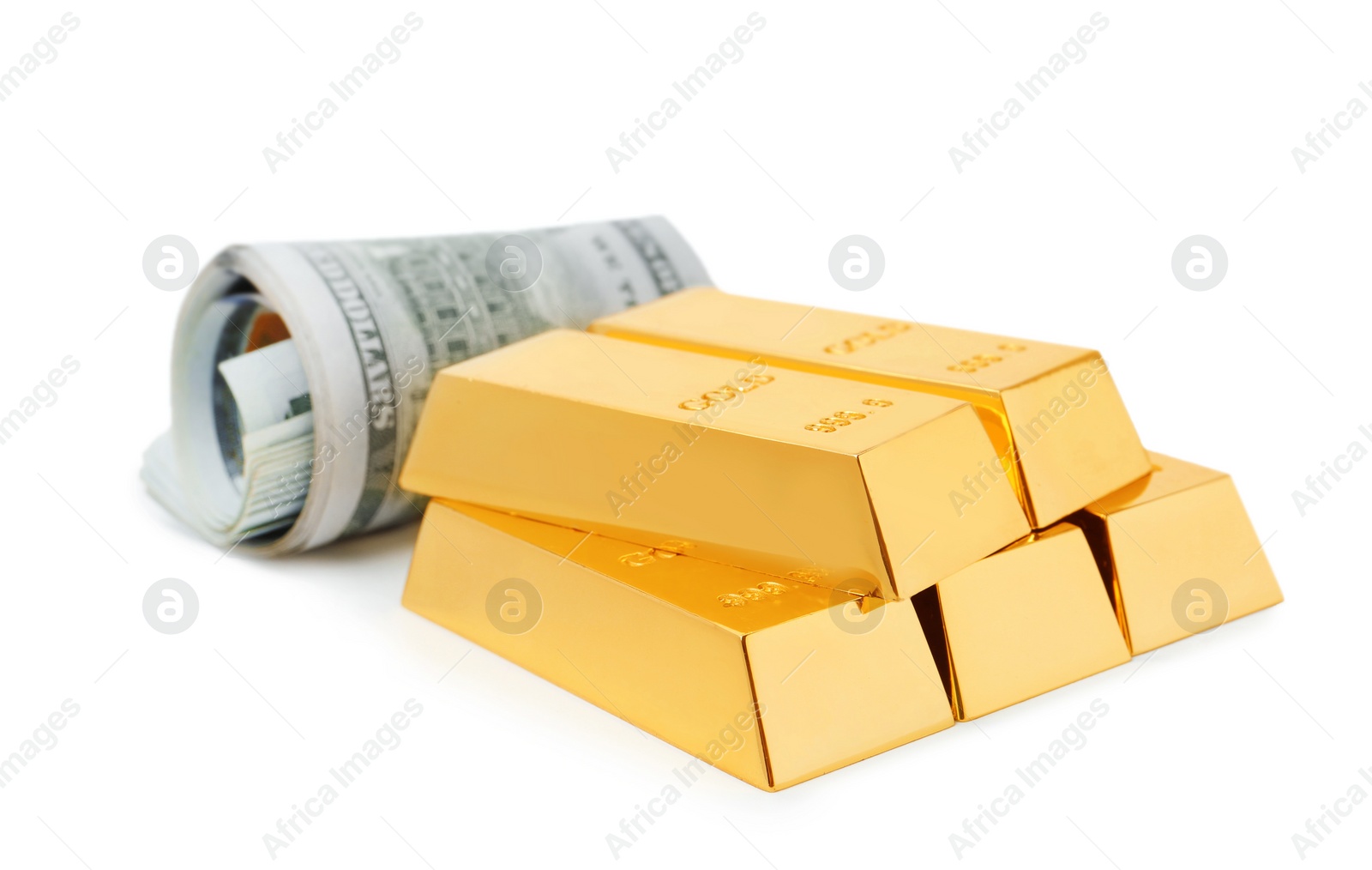 Photo of Shiny gold bars and dollar bills on white background