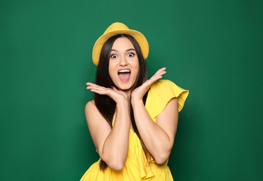 Photo of Portrait of emotional young woman in stylish clothes on color background
