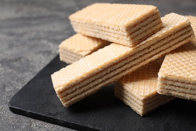 Photo of Delicious cream wafers on grey table, closeup