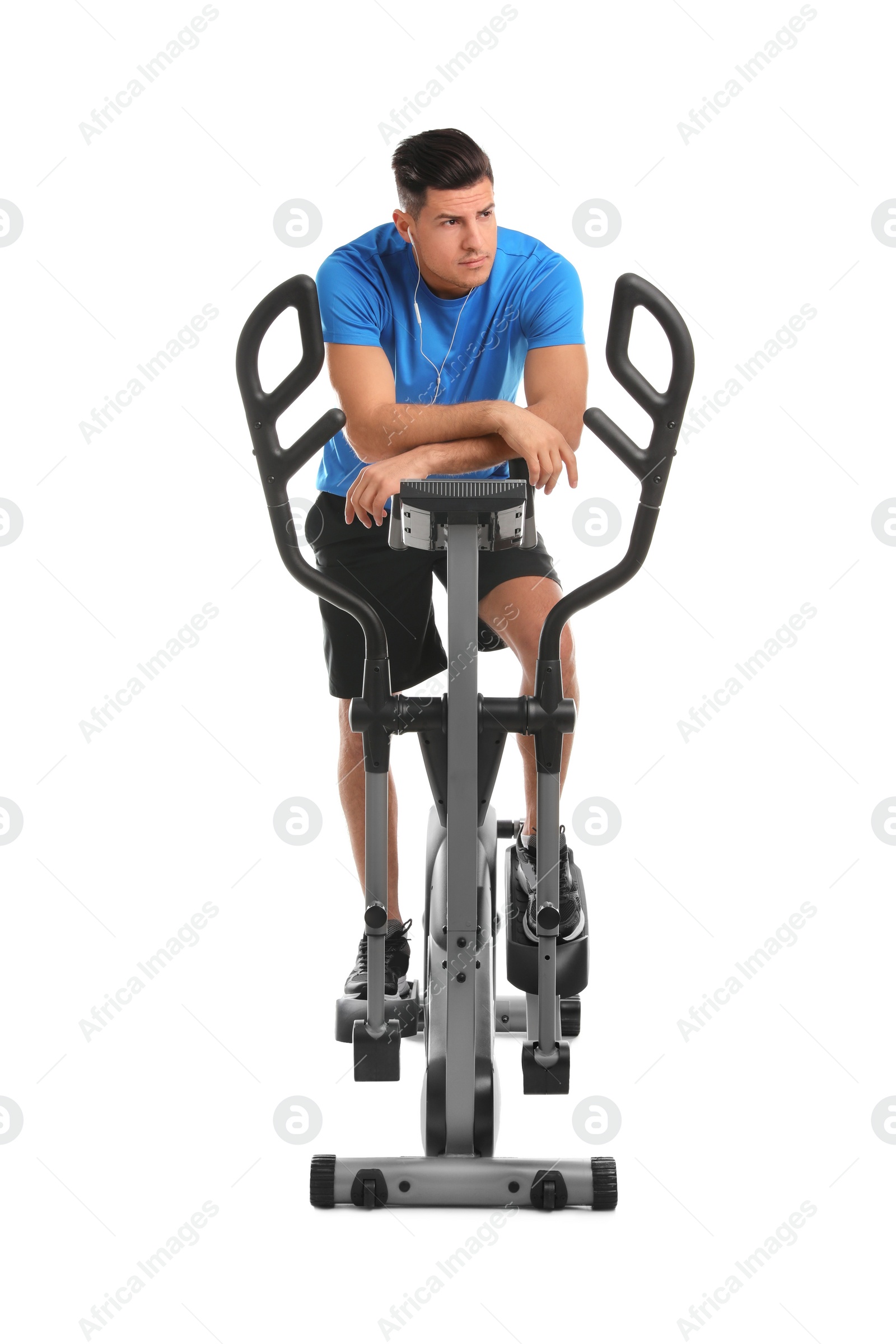 Photo of Man resting after training on modern elliptical machine against white background