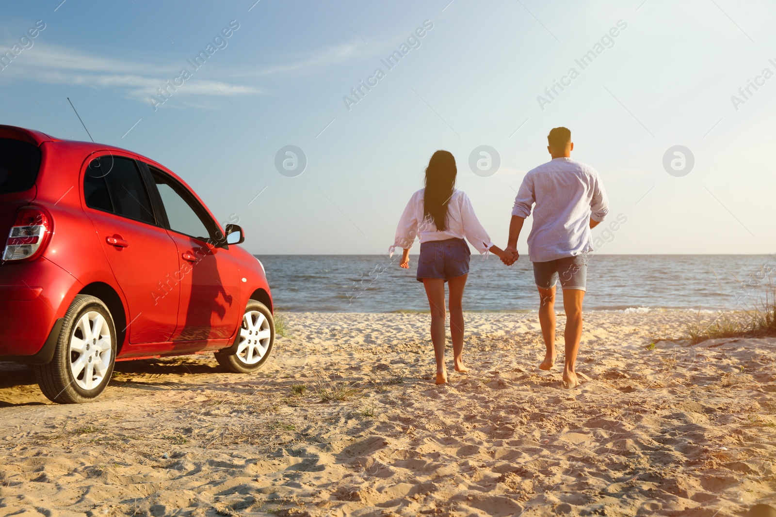 Photo of Lovely couple running on sandy beach. Summer trip