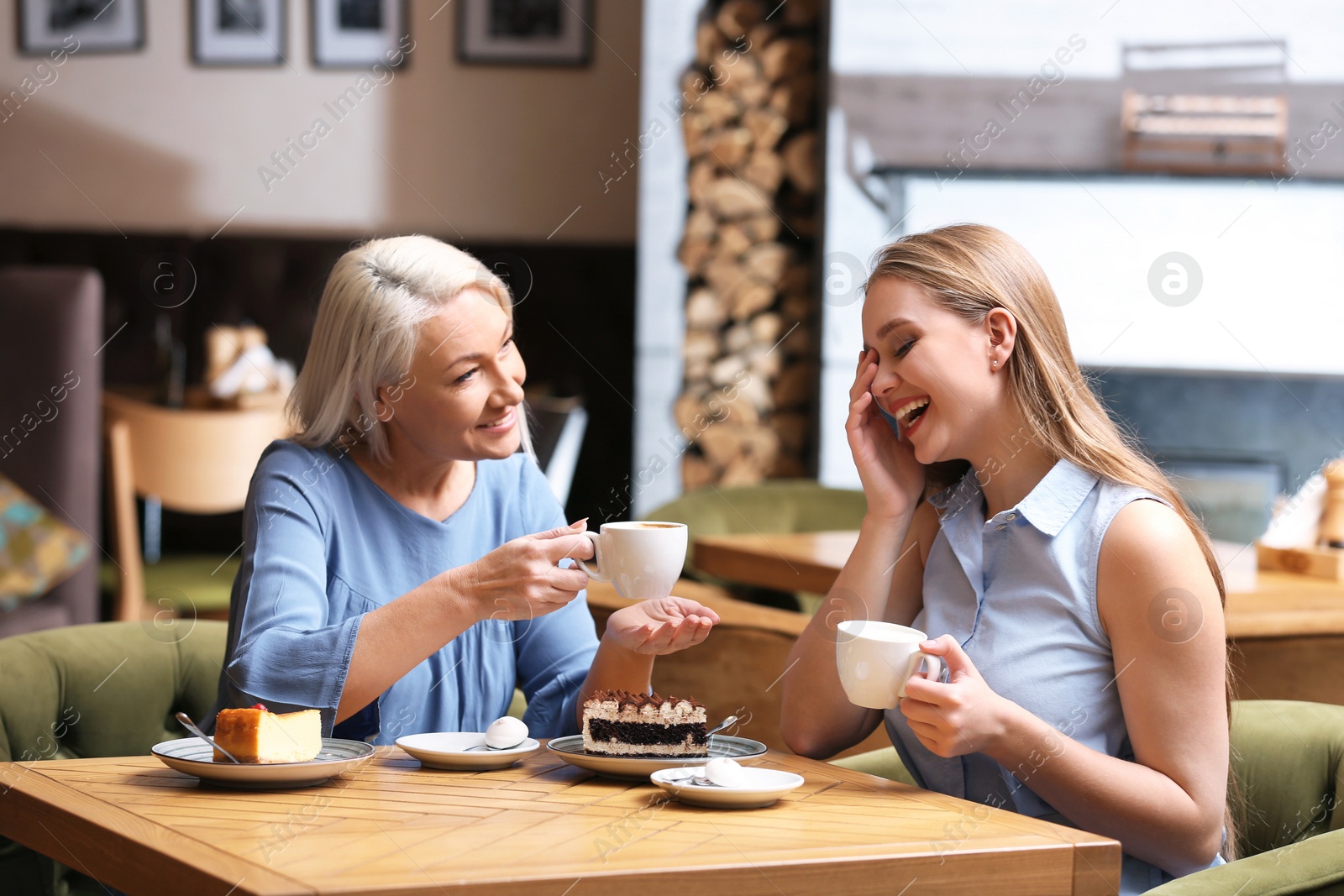 Photo of Mother and her adult daughter spending time together in cafe