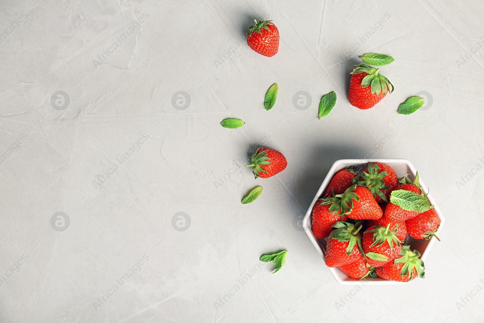 Photo of Flat lay composition with ripe red strawberries and mint on light background