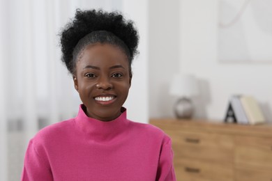 Portrait of beautiful young woman indoors. Space for text