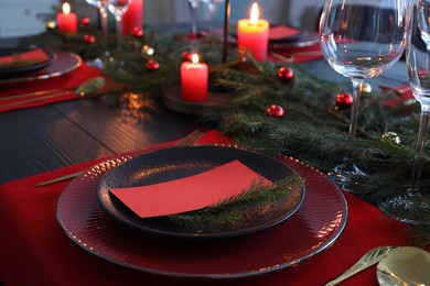 Elegant Christmas table setting with blank place card and festive decor