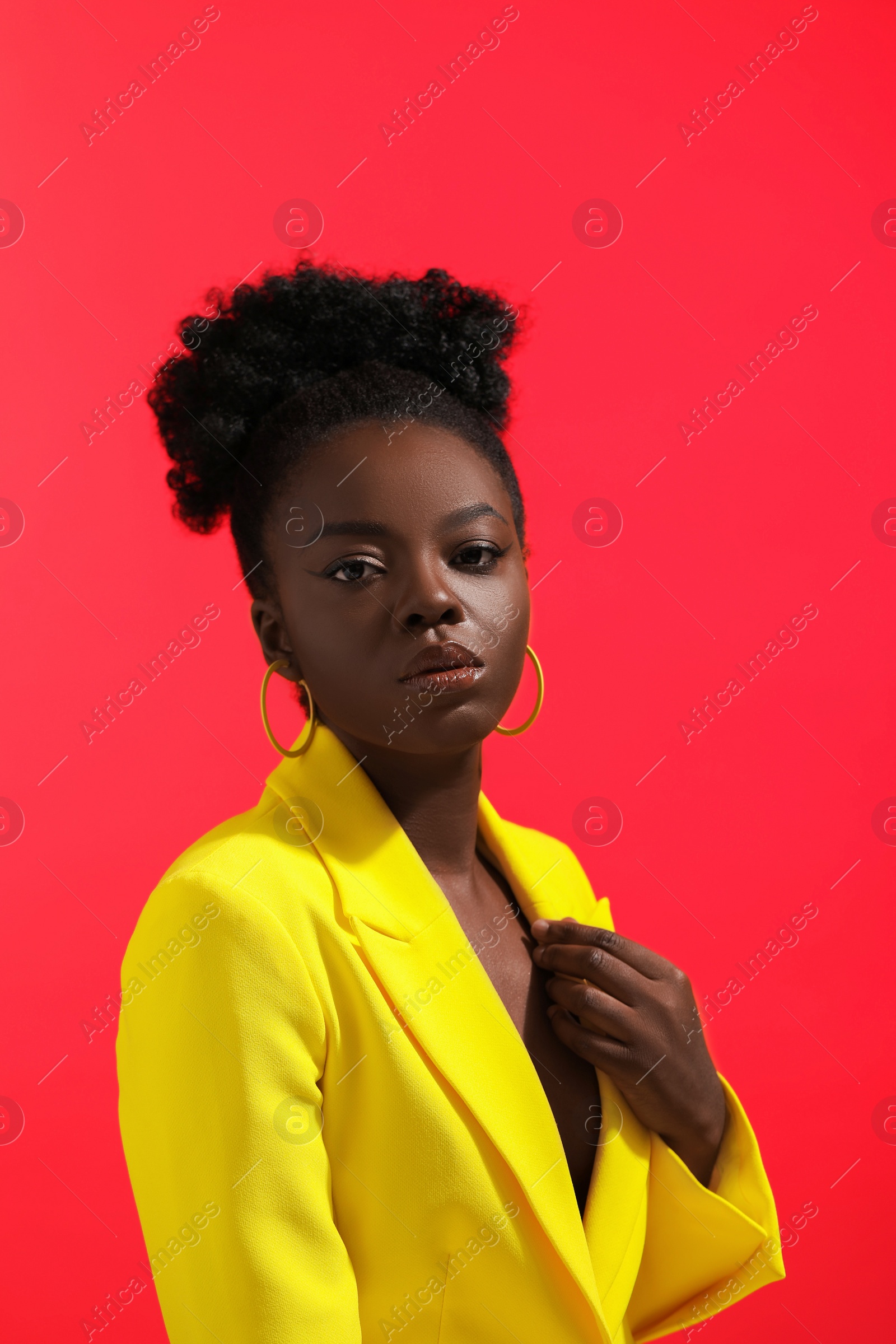 Photo of Fashionable portrait of beautiful woman on coral background