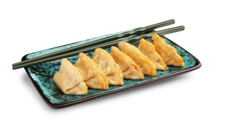 Photo of Delicious gyoza (asian dumplings) and chopsticks isolated on white