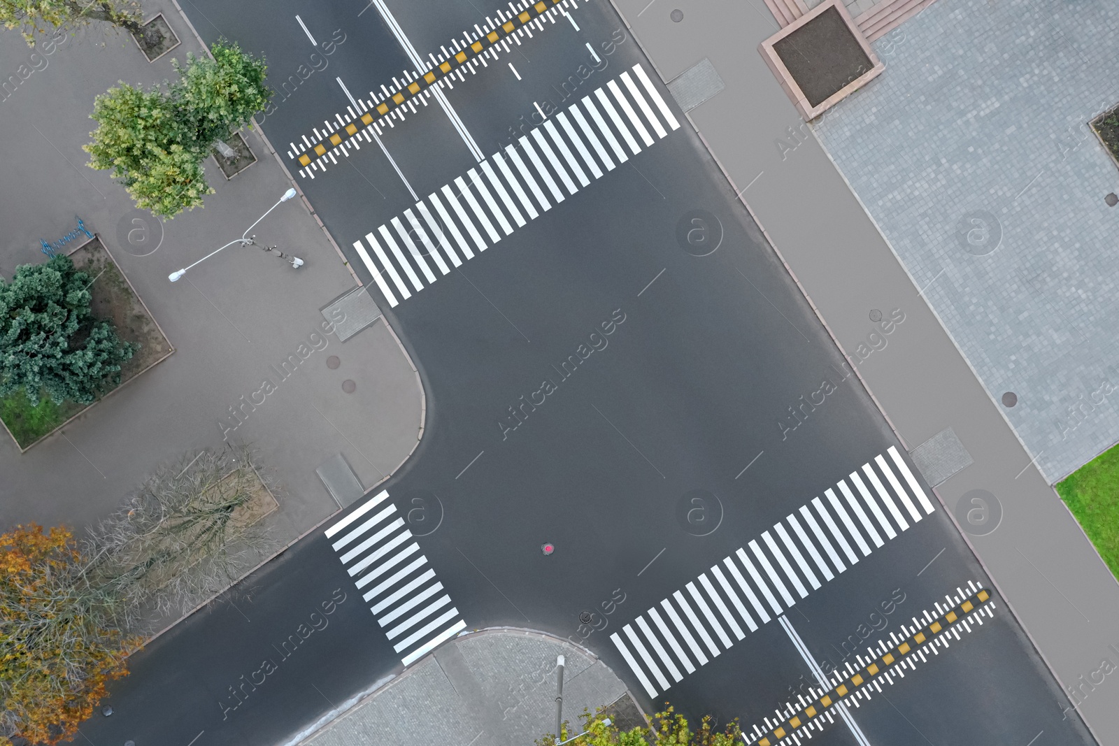 Image of Aerial view of white pedestrian crossings on modern city street