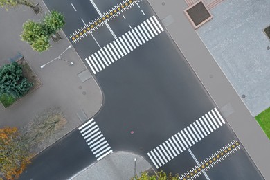 Image of Aerial view of white pedestrian crossings on modern city street