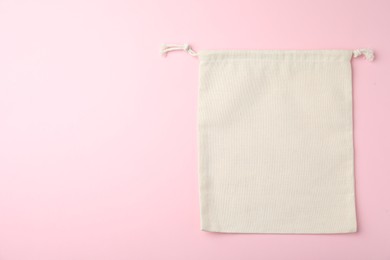 Photo of Cotton eco bag on pink background, top view. Space for text
