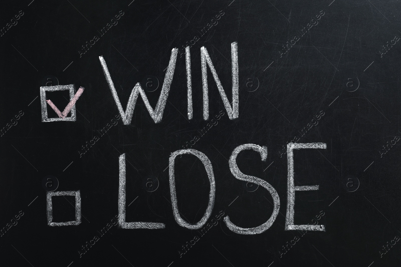 Photo of Motivational inscription written with chalk on blackboard. Victory concept