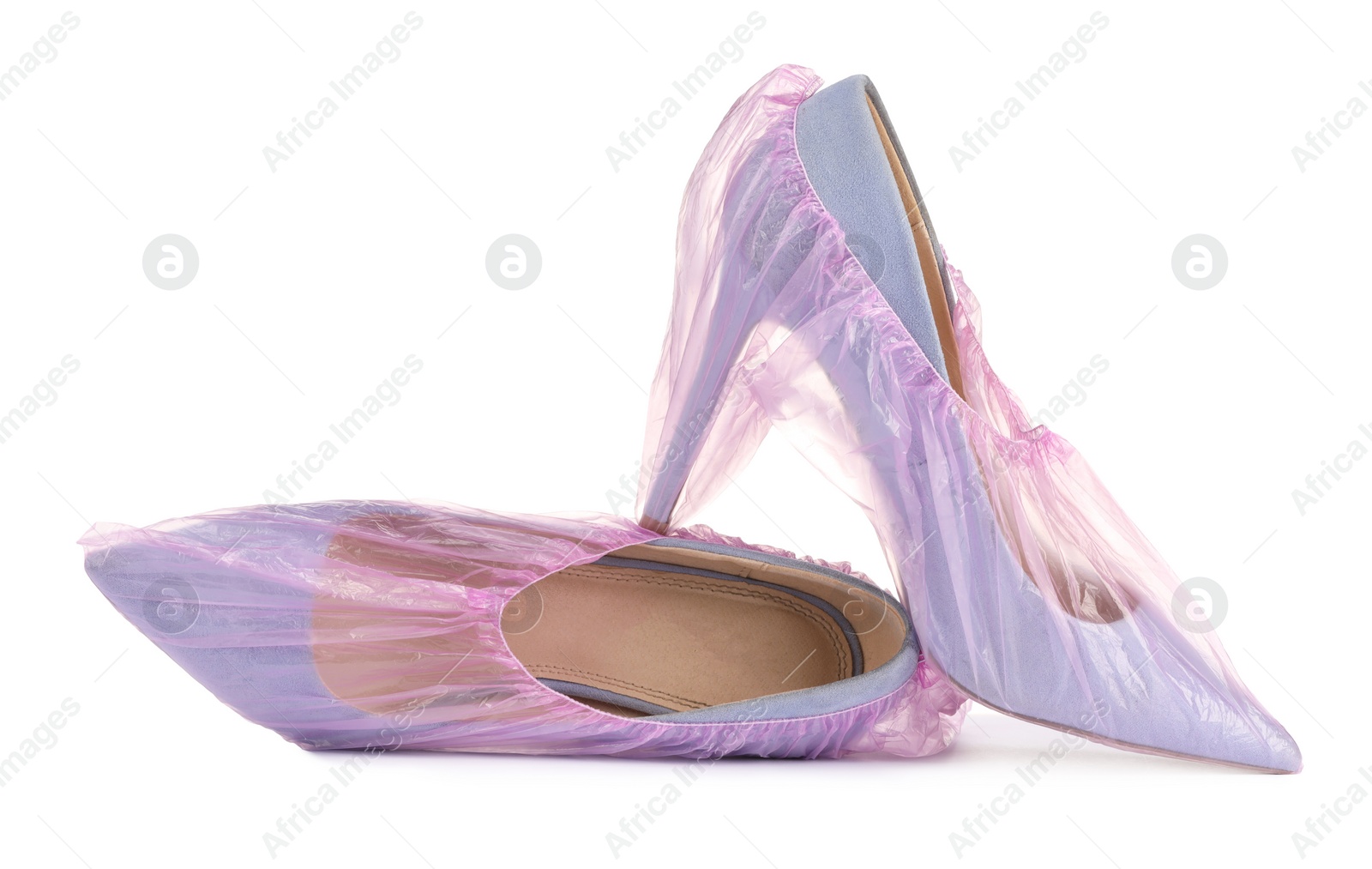 Photo of High heels in pink shoe covers isolated on white