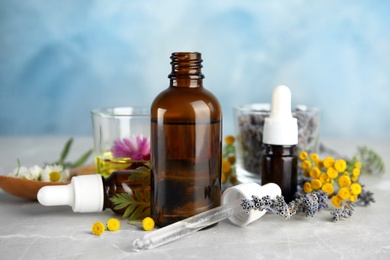 Photo of Composition with essential oils and flowers on table