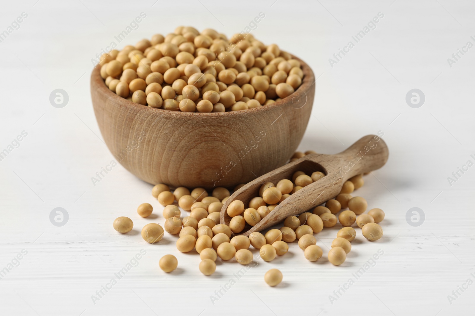 Photo of Bowl and scoop with soy on white table