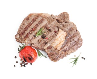 Photo of Piece of delicious grilled beef meat, rosemary, tomato and peppercorns isolated on white, above view