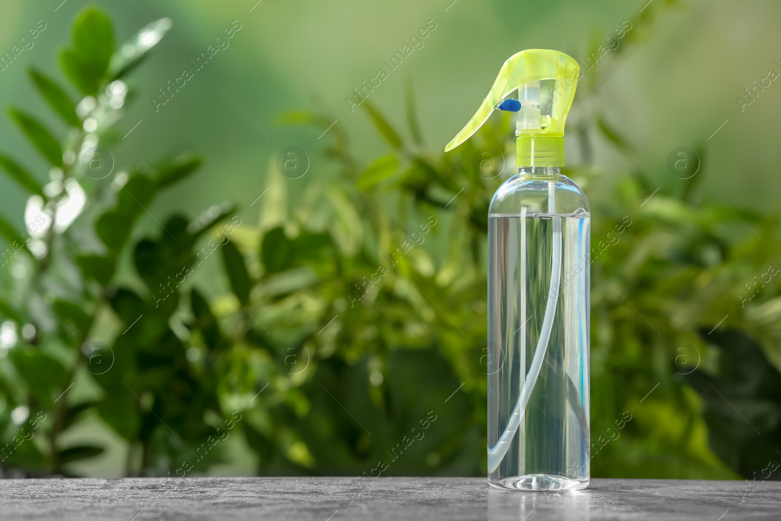 Photo of Spray air freshener on table against blurred background