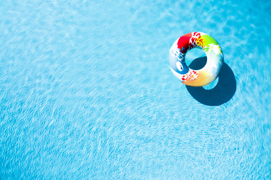 Image of Inflatable ring floating in swimming pool, top view with space for text. Summer vacation