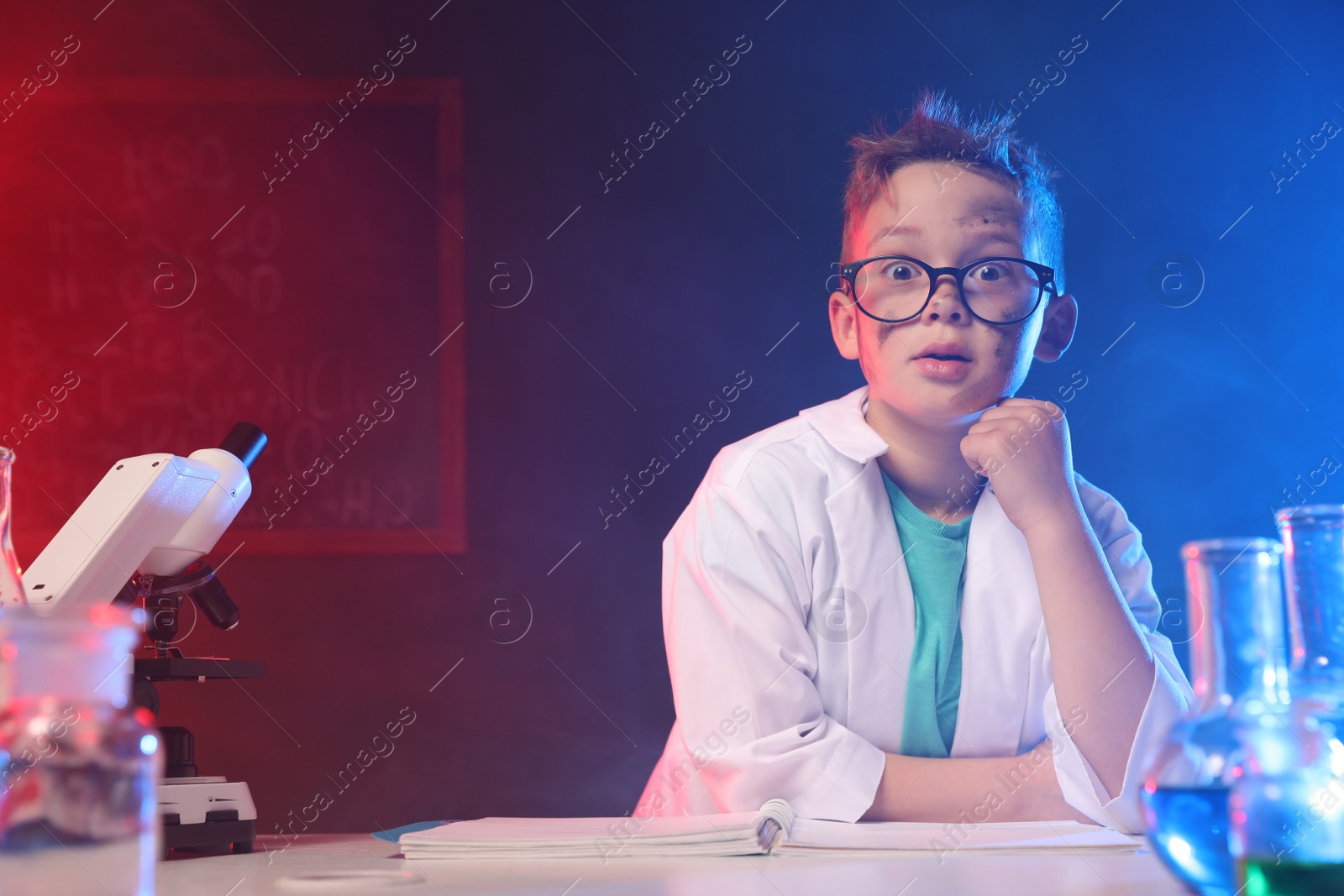 Photo of Emotional child in laboratory after explosion. Dangerous experiment