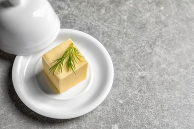 Photo of Dish with fresh butter on table. Space for text