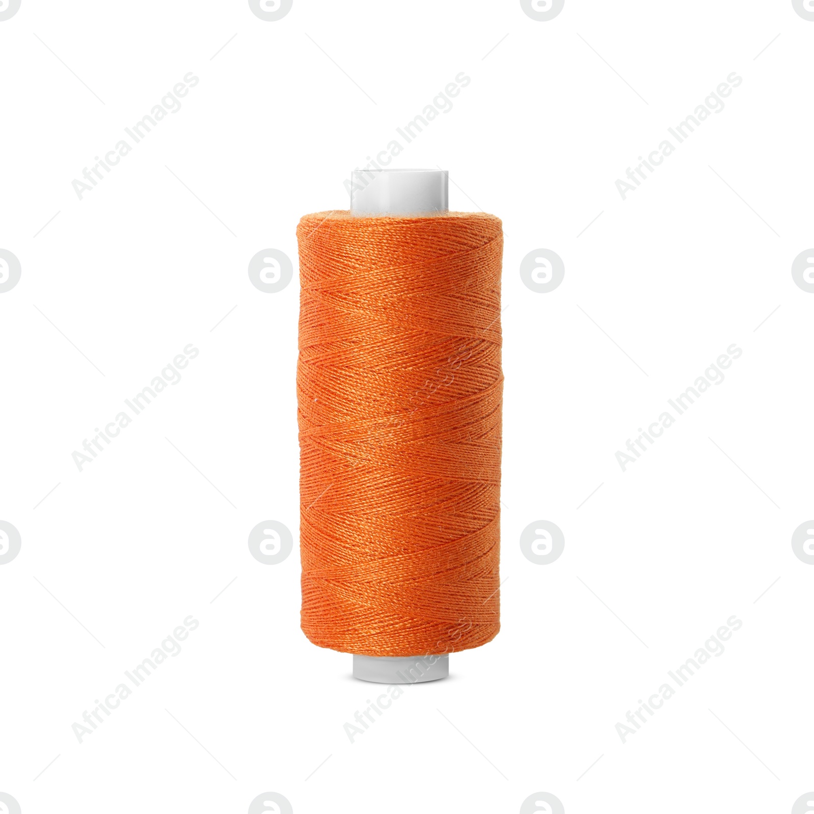 Photo of Spool of orange sewing thread isolated on white