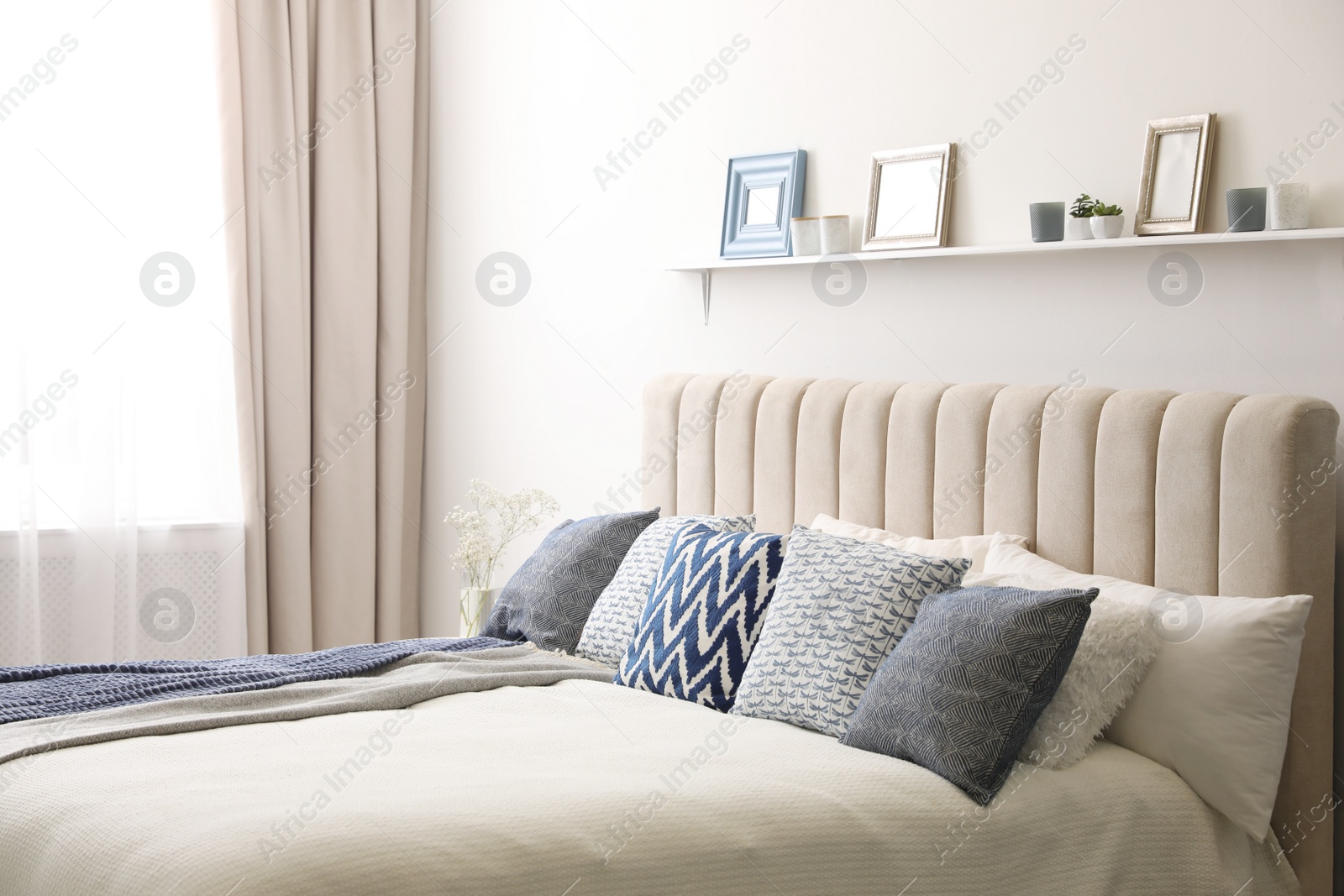 Photo of Comfortable bed with pillows in room. Stylish interior design