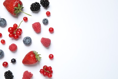 Mix of fresh berries on white background, flat lay