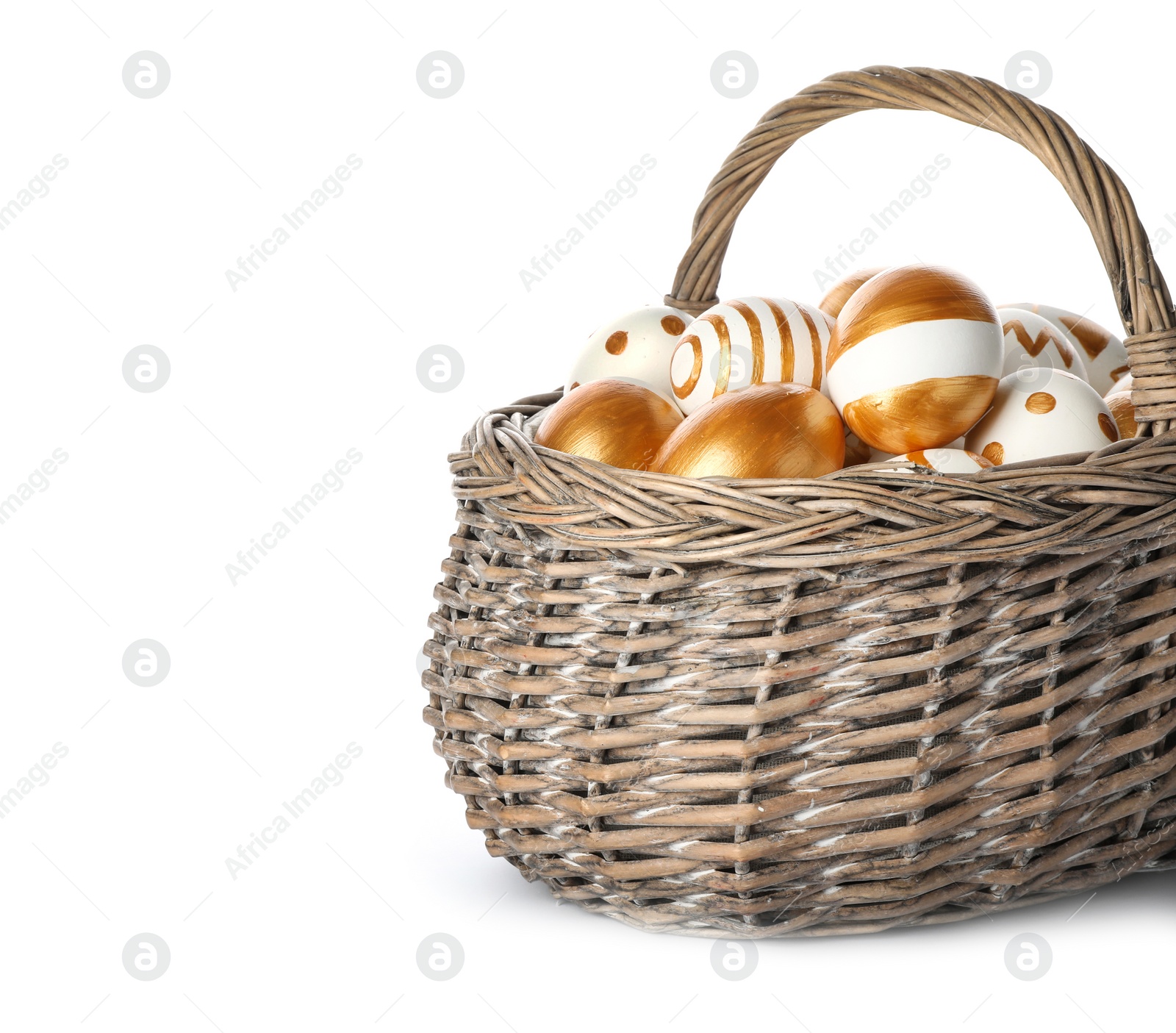 Photo of Wicker basket with traditional Easter eggs on white background, space for text