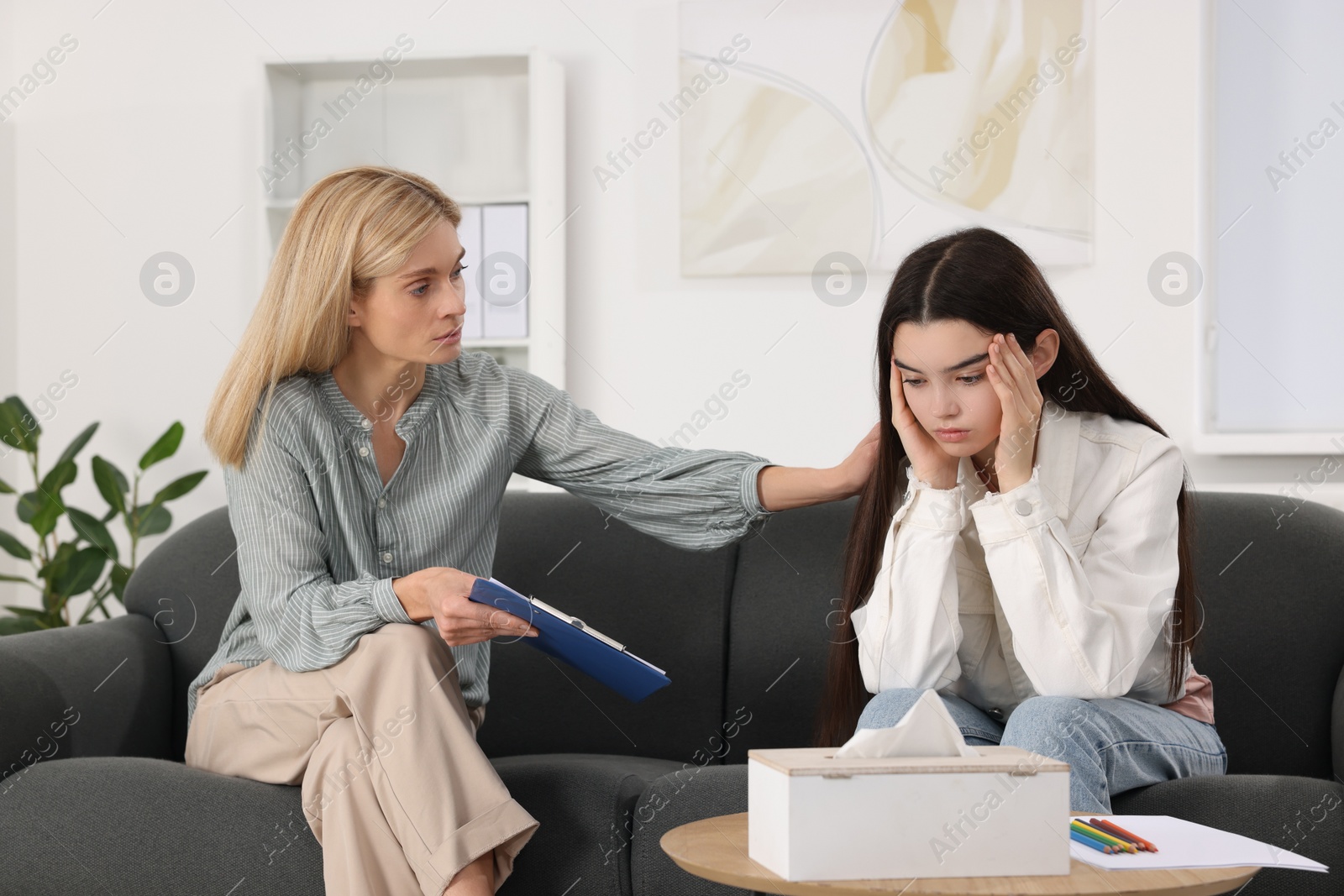 Photo of Psychologist working with teenage girl in office. Teenager problems