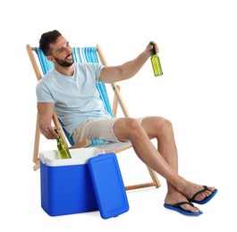 Photo of Happy man with bottles of beer near cool box on white background