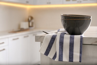 Kitchen towel and bowl on white table indoors, space for text