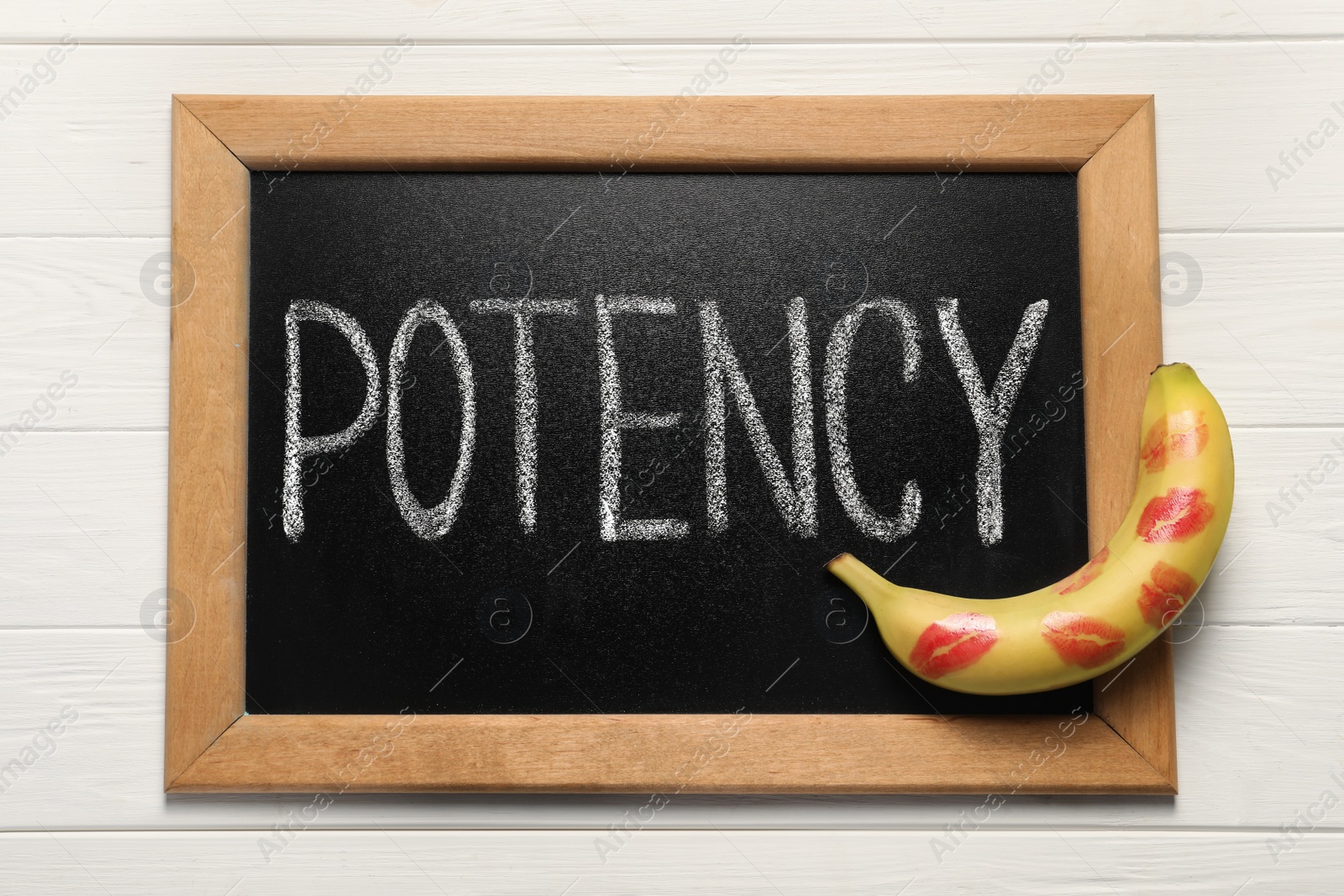 Photo of Blackboard with word Potency and banana on white wooden table, top view