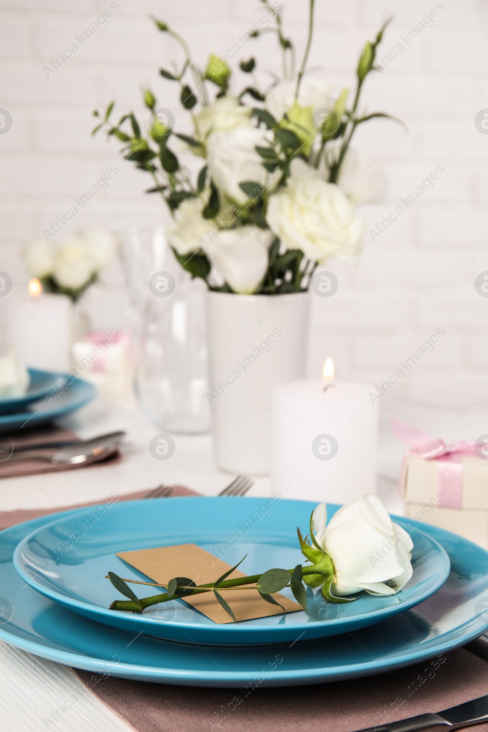 Photo of Elegant festive table setting with blank card in restaurant