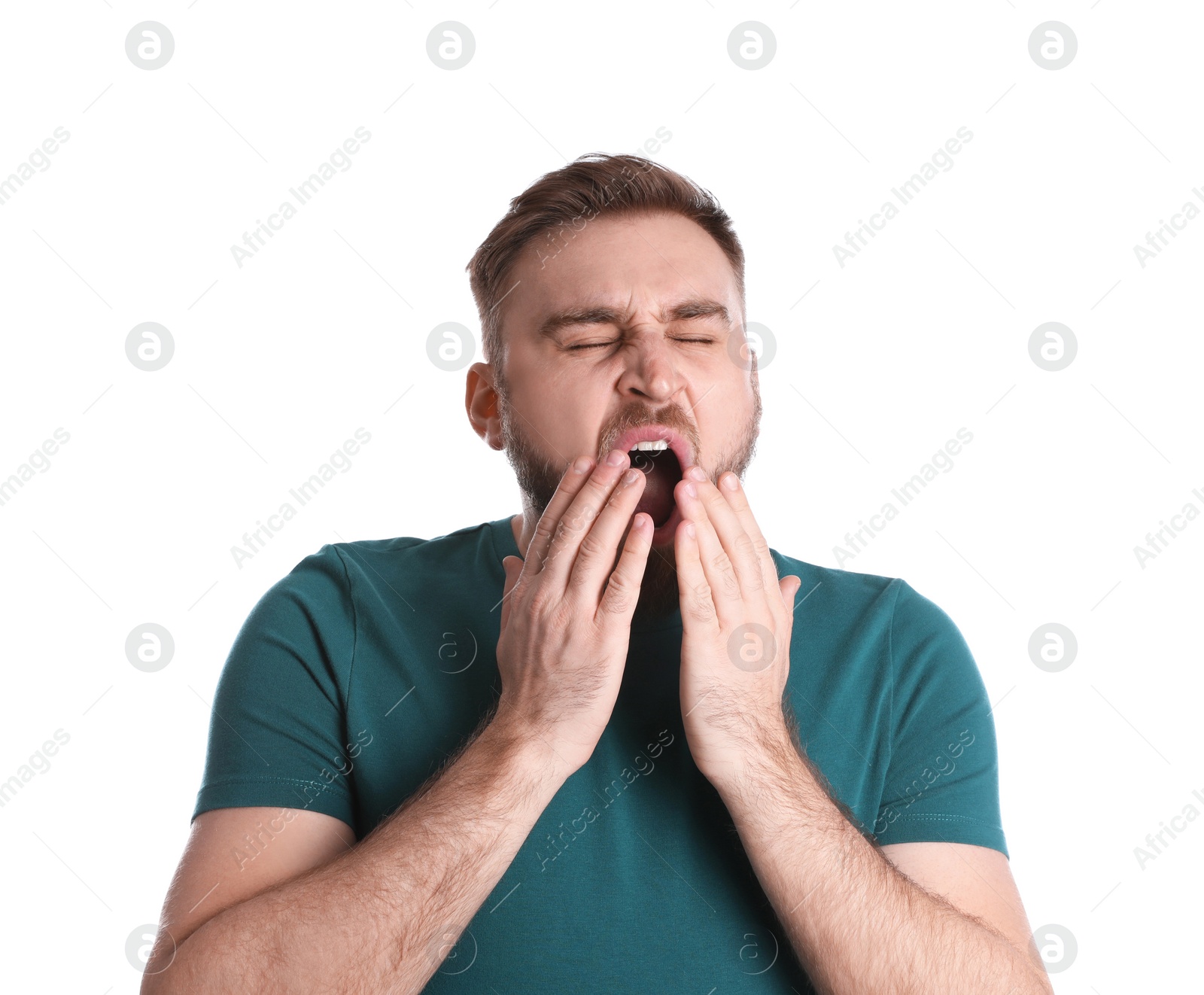 Photo of Sleepy young man yawning on white background