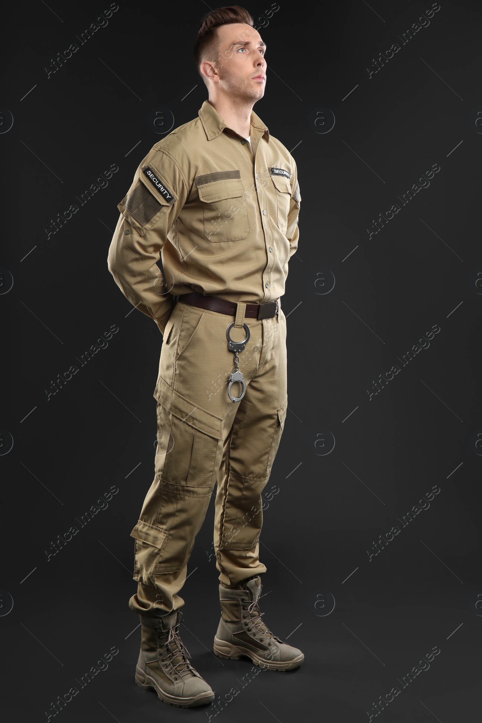 Photo of Male security guard in uniform on dark background