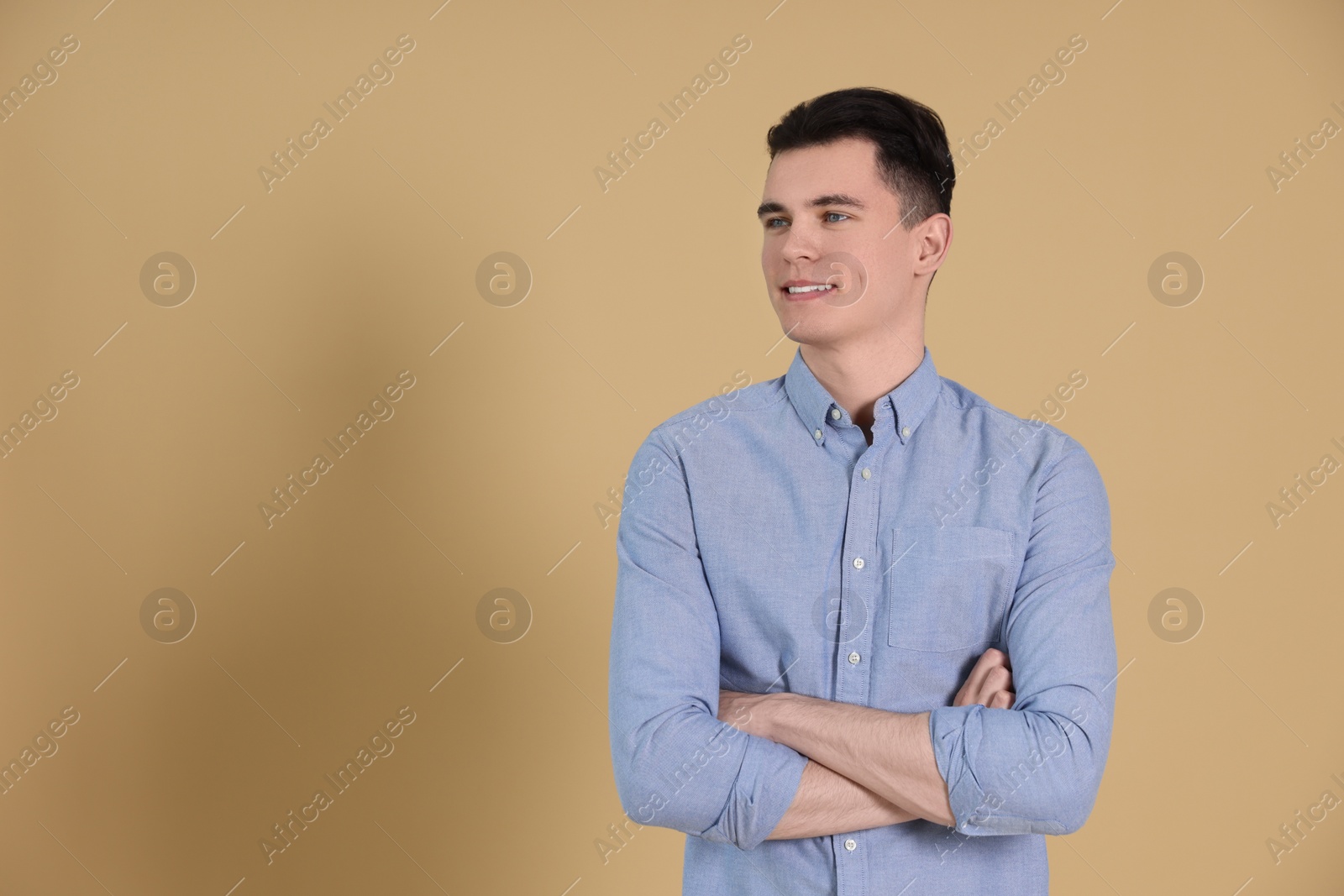 Photo of Portrait of handsome young man on beige background, space for text