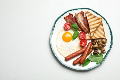 Photo of Breakfast with fried egg on light table, top view. Space for text