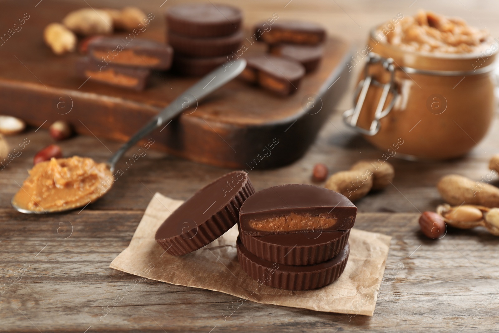 Photo of Delicious peanut butter cups on wooden table