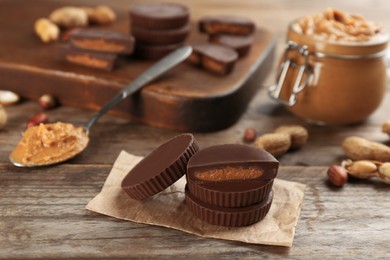 Delicious peanut butter cups on wooden table