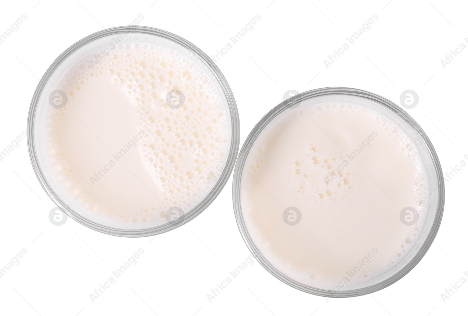 Photo of Glasses of fresh milk isolated on white, top view