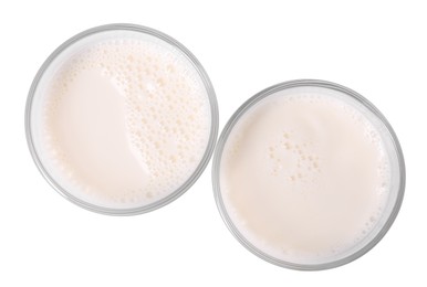 Glasses of fresh milk isolated on white, top view