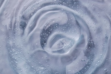 Photo of Texture of transparent shower gel as background, closeup