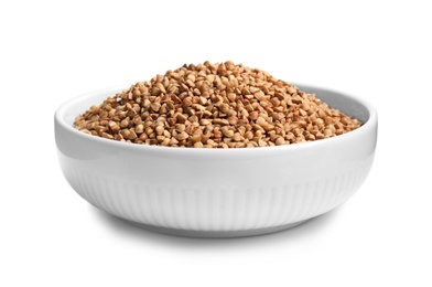 Photo of Bowl with uncooked buckwheat on white background