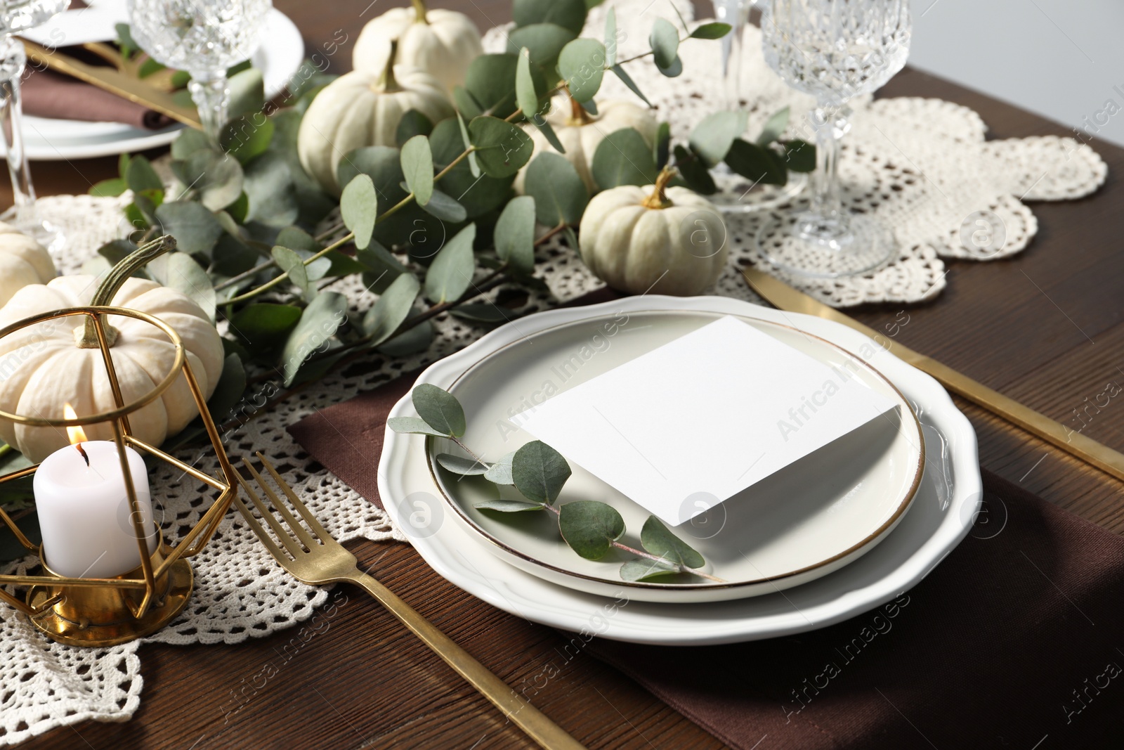 Photo of Beautiful autumn table setting with blank card and floral decor