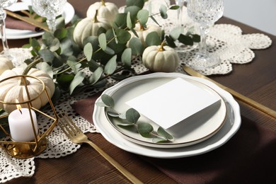 Photo of Beautiful autumn table setting with blank card and floral decor