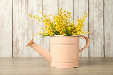 Photo of Bouquet of beautiful mimosa flowers on wooden table