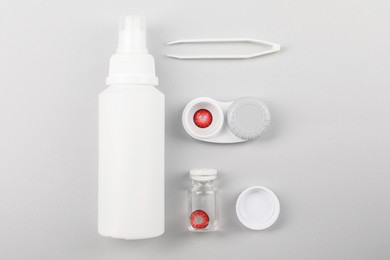 Photo of Flat lay composition with color contact lenses on light grey background